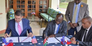 U.S. Ambassador Kyle McCarter (left) and Craftskills Chairman Dr. Kenneth Namunje sign a grant awarded to Craftskills Energy Ltd for a feasibility study to develop a 50-megawatt wind power plant with integrated battery storage capacity in Kajiado, Kenya.