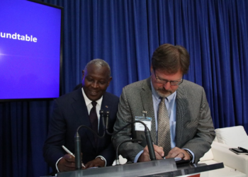 Equity Group Managing Director and CEO James Mwangi and John Deere Head of Business for Africa, Asia and the Middle East, Jason Brantley sign a financing collaboration agreement between Equity Group Holdings and John Deere. [Photo/Equity]